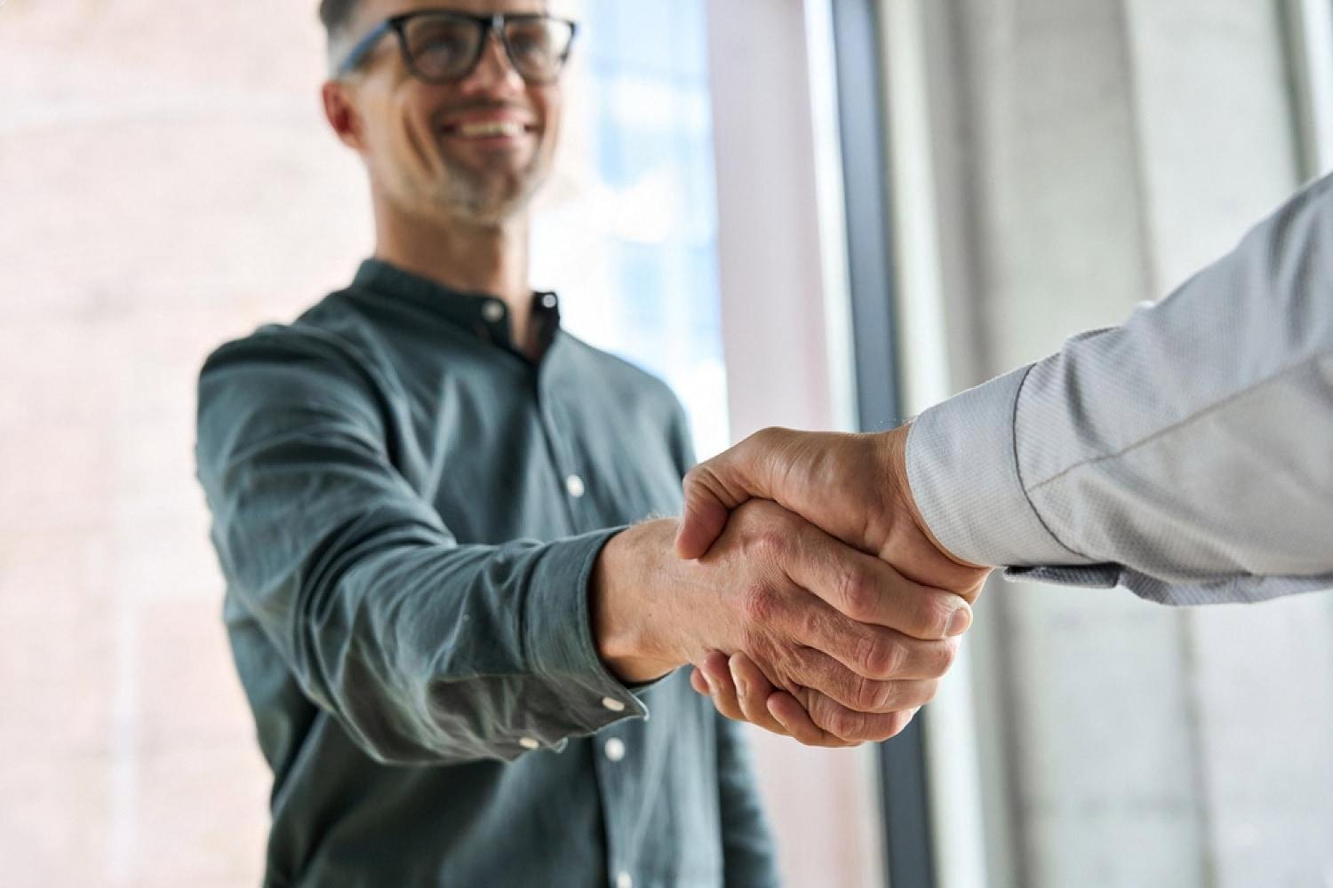 Business handshake during customer onboarding in the UAE